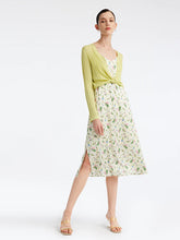 Woman wearing short cardigan and floral dress